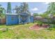 Inviting blue home with a covered front porch and well-manicured lawn at 1912 E 97Th Ave, Tampa, FL 33612