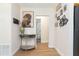 Hallway with light colored walls and light hardwood style floors leading to other rooms at 1912 E 97Th Ave, Tampa, FL 33612