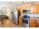 Modern kitchen with stainless steel appliances open to the living room at 1912 E 97Th Ave, Tampa, FL 33612