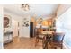 Bright dining area flowing into the kitchen with stainless steel appliances and oak cabinets at 1912 E 97Th Ave, Tampa, FL 33612