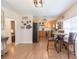 Bright dining area flowing into the kitchen with stainless steel appliances and oak cabinets at 1912 E 97Th Ave, Tampa, FL 33612