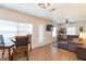 Open-concept living room with a ceiling fan, a comfortable sofa, and lots of natural light at 1912 E 97Th Ave, Tampa, FL 33612