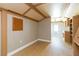 Open living room boasts hardwood floors, neutral walls, and beams at 1912 E 97Th Ave, Tampa, FL 33612