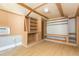 Interior of shed featuring wood-look flooring, shelving, and built-in cabinets at 1912 E 97Th Ave, Tampa, FL 33612