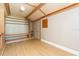 Interior of shed featuring wood-look flooring, shelving, and built-in cabinets at 1912 E 97Th Ave, Tampa, FL 33612