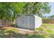 Backyard storage shed with double doors on a concrete slab at 1912 E 97Th Ave, Tampa, FL 33612