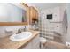 Bathroom with wood vanity and glass block shower at 211 Pasadena N Ave # 109, St Petersburg, FL 33710