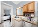 Bathroom vanity with wood cabinets, and view into the bedroom at 211 Pasadena N Ave # 109, St Petersburg, FL 33710