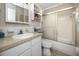 Bathroom featuring tiled walls, vanity sink, toilet and shower stall with glass door at 211 Pasadena N Ave # 109, St Petersburg, FL 33710