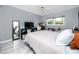 Bedroom featuring a mirror, tile floor, large window, and ceiling fan at 211 Pasadena N Ave # 109, St Petersburg, FL 33710
