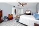Bedroom with wood-look tile flooring, ceiling fan, and double closets at 211 Pasadena N Ave # 109, St Petersburg, FL 33710