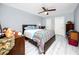 Bedroom with wood-look tile flooring, ceiling fan, and a double bed at 211 Pasadena N Ave # 109, St Petersburg, FL 33710