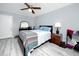 Bedroom with neutral walls, wood-look floors, ceiling fan, and dresser and mirror at 211 Pasadena N Ave # 109, St Petersburg, FL 33710