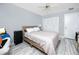 Bedroom with wood-look tile flooring, ceiling fan, closet and light walls at 211 Pasadena N Ave # 109, St Petersburg, FL 33710