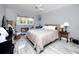Bedroom with wood-look tile flooring, ceiling fan, and large window at 211 Pasadena N Ave # 109, St Petersburg, FL 33710