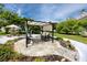 Condo courtyard featuring a cozy seating area with flagstone and an umbrella table at 211 Pasadena N Ave # 109, St Petersburg, FL 33710
