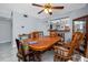 Dining area featuring a large wooden table, vintage-style chairs, and view to the kitchen at 211 Pasadena N Ave # 109, St Petersburg, FL 33710