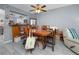 Dining area leading to an open kitchen with a vintage wooden table and comfortable seating at 211 Pasadena N Ave # 109, St Petersburg, FL 33710