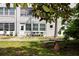Exterior view of condo building with mature landscaping at 211 Pasadena N Ave # 109, St Petersburg, FL 33710