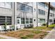 Condominium featuring well-lit windows, manicured lawn, and an inviting entrance at 211 Pasadena N Ave # 109, St Petersburg, FL 33710