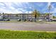 Three story condo building with palm trees and parking at 211 Pasadena N Ave # 109, St Petersburg, FL 33710