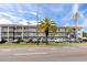 Three story condo building with palm trees and parking at 211 Pasadena N Ave # 109, St Petersburg, FL 33710