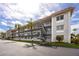 Exterior shot of a three story condo building with balconies and stairs at 211 Pasadena N Ave # 109, St Petersburg, FL 33710