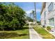 Condominium view features mature trees, lush lawn and a sidewalk at 211 Pasadena N Ave # 109, St Petersburg, FL 33710