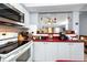 Bright kitchen with stainless steel oven, microwave and pass-through opening to another room at 211 Pasadena N Ave # 109, St Petersburg, FL 33710