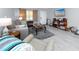 Cozy living room featuring comfortable seating, gray rug, and modern gray tile flooring at 211 Pasadena N Ave # 109, St Petersburg, FL 33710