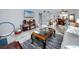 Open living room with tile flooring, gray sofa, dark coffee table, and entertainment center at 211 Pasadena N Ave # 109, St Petersburg, FL 33710