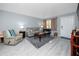 Bright living room with neutral tones, tile floors, comfortable seating, and ample natural light at 211 Pasadena N Ave # 109, St Petersburg, FL 33710