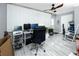 Home office featuring wood-look floors, ceiling fan, and large picture window at 211 Pasadena N Ave # 109, St Petersburg, FL 33710