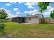 Landscaped backyard with a screen patio, wooden deck, and privacy fence for outdoor enjoyment at 2325 W Knollwood Pl, Tampa, FL 33604