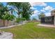 Well-maintained backyard with a wooden deck, privacy fence, and beautifully landscaped areas at 2325 W Knollwood Pl, Tampa, FL 33604