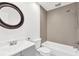 Bright bathroom featuring a white vanity and modern, tiled bath and shower combo at 2325 W Knollwood Pl, Tampa, FL 33604