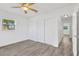 Bedroom with light gray flooring, closet space, and plenty of natural light from a window at 2325 W Knollwood Pl, Tampa, FL 33604