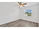 Bright bedroom featuring natural light from a window and modern light gray flooring at 2325 W Knollwood Pl, Tampa, FL 33604