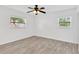 Bedroom featuring natural light from two windows and modern light gray flooring at 2325 W Knollwood Pl, Tampa, FL 33604
