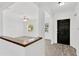 Bright entryway showcasing modern flooring and freshly painted walls, leading to a spacious living area at 2325 W Knollwood Pl, Tampa, FL 33604