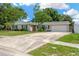 Charming single-story home with a well-manicured lawn and a spacious driveway at 2325 W Knollwood Pl, Tampa, FL 33604