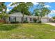Inviting home exterior showing mature trees, a green lawn, and tidy landscaping at 2325 W Knollwood Pl, Tampa, FL 33604
