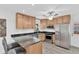 Well-lit kitchen featuring stainless steel appliances and countertop seating with views of the backyard at 2325 W Knollwood Pl, Tampa, FL 33604