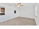 Bright living room featuring new flooring, fresh paint, and a modern ceiling fan at 2325 W Knollwood Pl, Tampa, FL 33604