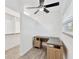 Cozy office space featuring an L-shaped desk, modern ceiling fan and natural light at 2325 W Knollwood Pl, Tampa, FL 33604