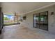 Spacious screened patio with ceiling fan, sliding glass doors, and view of the fenced backyard at 2325 W Knollwood Pl, Tampa, FL 33604