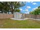 Backyard shed features a gravel surround and ample storage; enclosed by a wood fence at 2325 W Knollwood Pl, Tampa, FL 33604