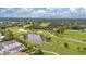 Scenic aerial view of golf course community, showcasing lush greens, water features, and nearby residential properties at 267 Snell Isle Ne Blvd, St Petersburg, FL 33704