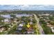 Stunning aerial view showcasing a charming neighborhood nestled among trees with city skyline and waterway backdrop at 267 Snell Isle Ne Blvd, St Petersburg, FL 33704