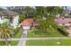 Charming pink home with tile roof, green lawn, and palm trees, set in a tranquil neighborhood offering curb appeal at 267 Snell Isle Ne Blvd, St Petersburg, FL 33704